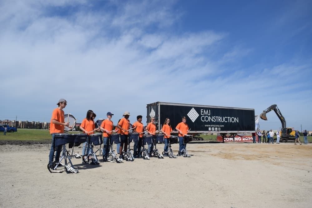 A drumline from Wakeland High School performs ahead of H-E-B breaking ground for the future Frisco location. (Matt Payne/Community Impact Newspaper)