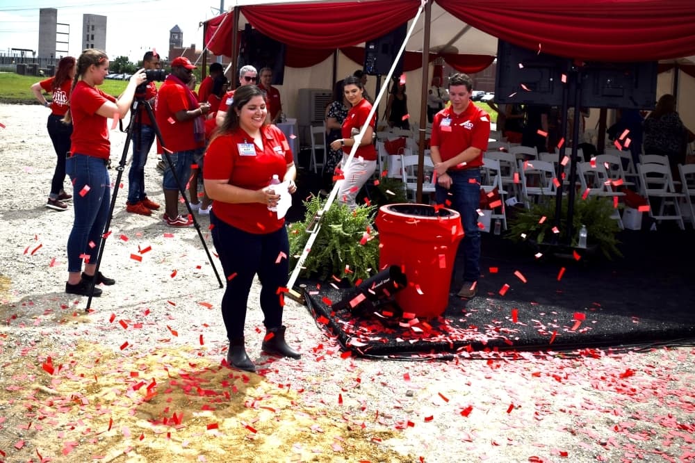 H-E-B partners celebrate with red confetti following the groundbreaking ceremony for the future Frisco location. (Matt Payne/Community Impact Newspaper)