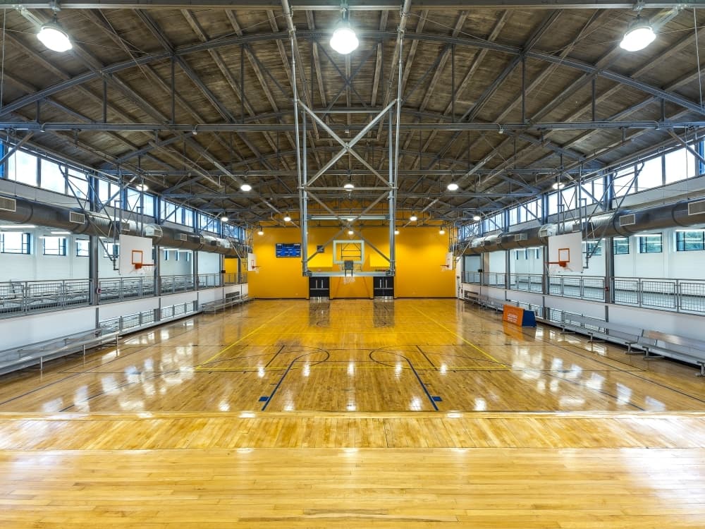 Renovations to the historic Missouri City gym included the creation of a new lobby, basketball rims, a fitness center, a game center, a juice and coffee bar, a meeting space, and a museum. (Courtesy Teal Construction Company)
