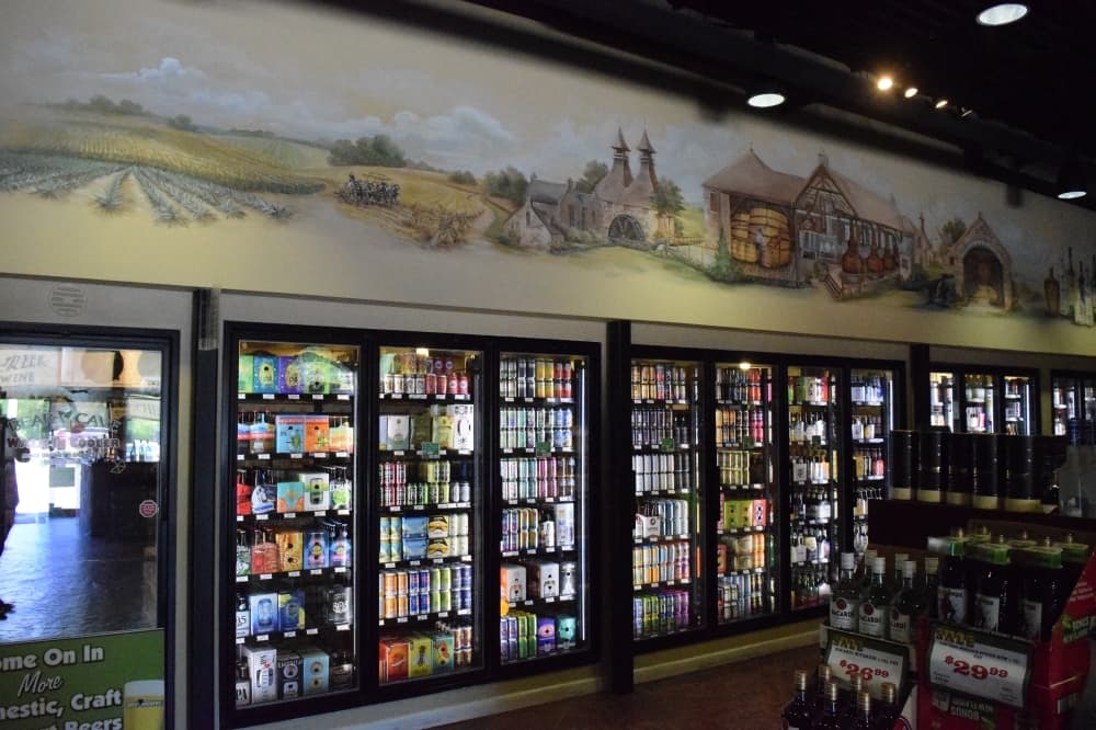 A mural depicting alcohol fermentation, from harvest to bottle, is painted across a wall at Bear Creek Spirits & Wine.