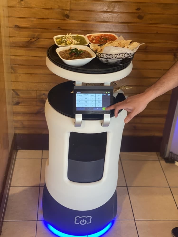 A robot server brings food to patrons at Rock N. Grill. (Brian Rash/Community Impact Newspaper)