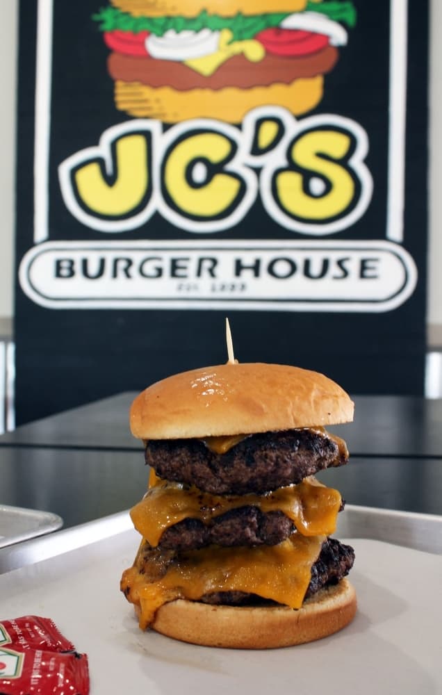 Jay Cockerell "JC," founder of JC's Burger House, named his three-patty burger The Toddzilla. It costs $18.99. (Karen Chaney/Community Impact Newspaper)