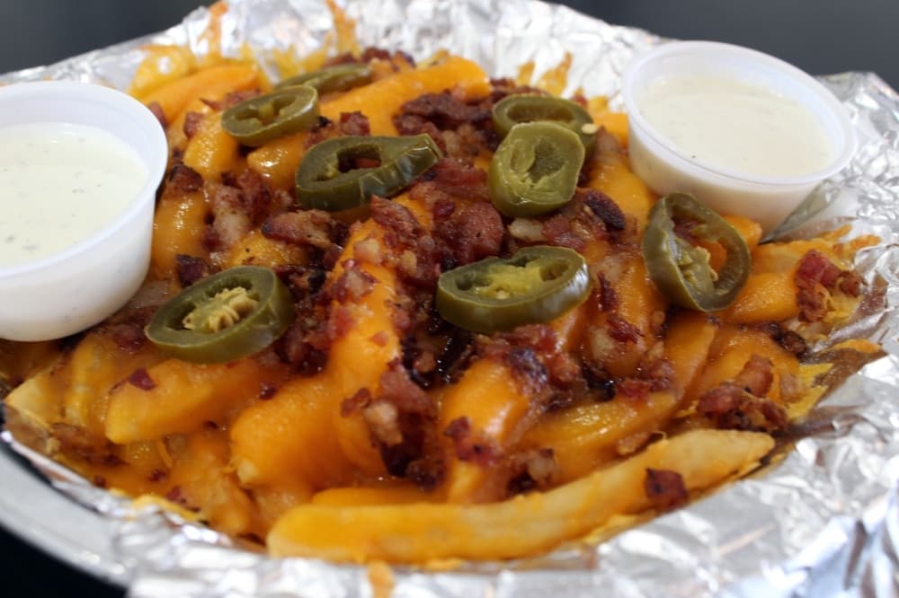 Cheese Fries (full order $6.99) are topped with cheddar, bacon and jalapenos. (Karen Chaney/Community Impact Newspaper)