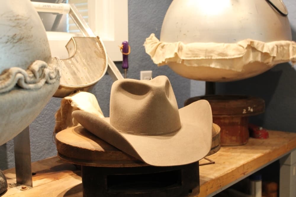 After they are steamed, pressed, ironed, and sanded, the hats are shaped. (Megan Cardona/Community Impact Newspaper)