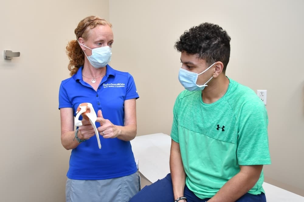 doctor showing item to patient 