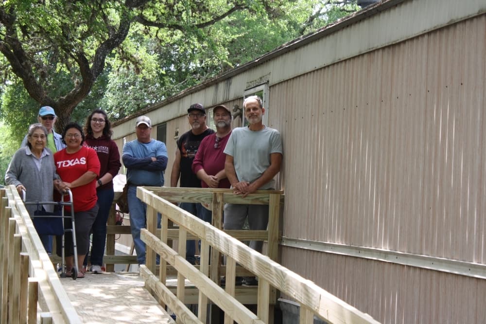 Volunteers display their efforts after building a ramp for a Hays County resident in April. (Courtesy Gary Nelson)