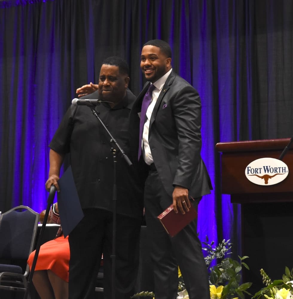 New councilmember Dr. Jared Williams and his father after Williams was sworn in. (Steven Ryzewski/Community Impact Newspaper)