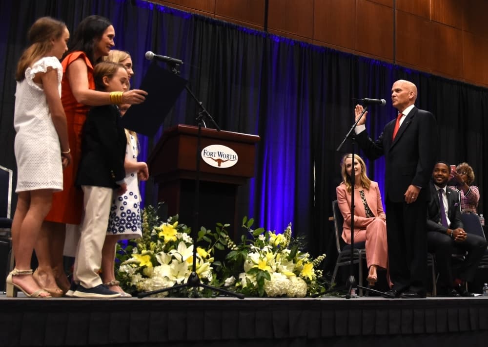 Leonard Firestone is sworn in as District 7 councilmember on the Fort Worth City Commission with his family onstage. (Steven Ryzewski/Community Impact Newspaper)