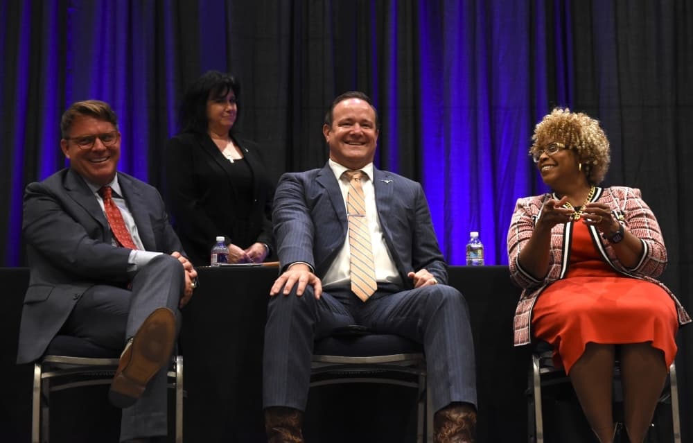 Council members Michael Crain, left, Cary Moon and Gyna Bivens share a lighthearted moment during the night's festivities. (Steven Ryzewski/Community Impact Newspaper)