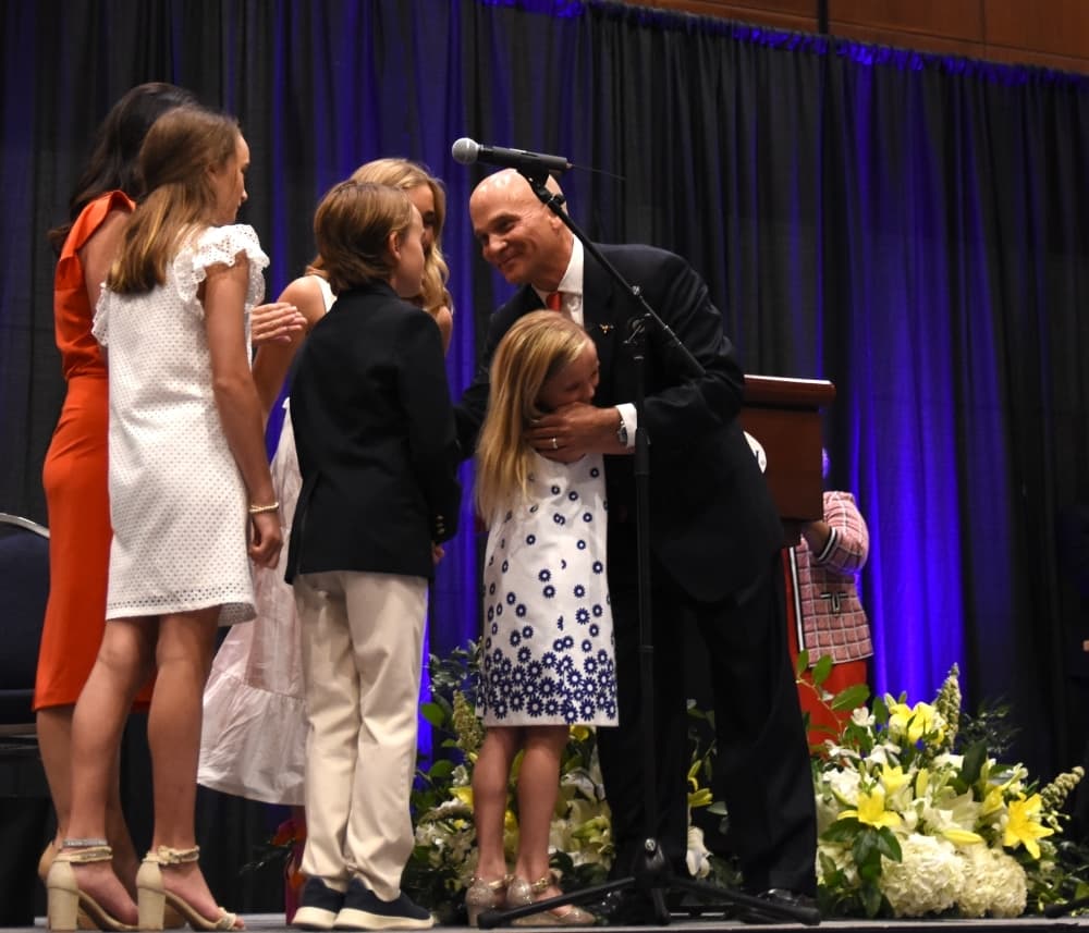 Leonard Firestone shares a moment with his family after being sworn in as councilmember for District 7. (Steven Ryzewski/Community Impact Newspaper)
