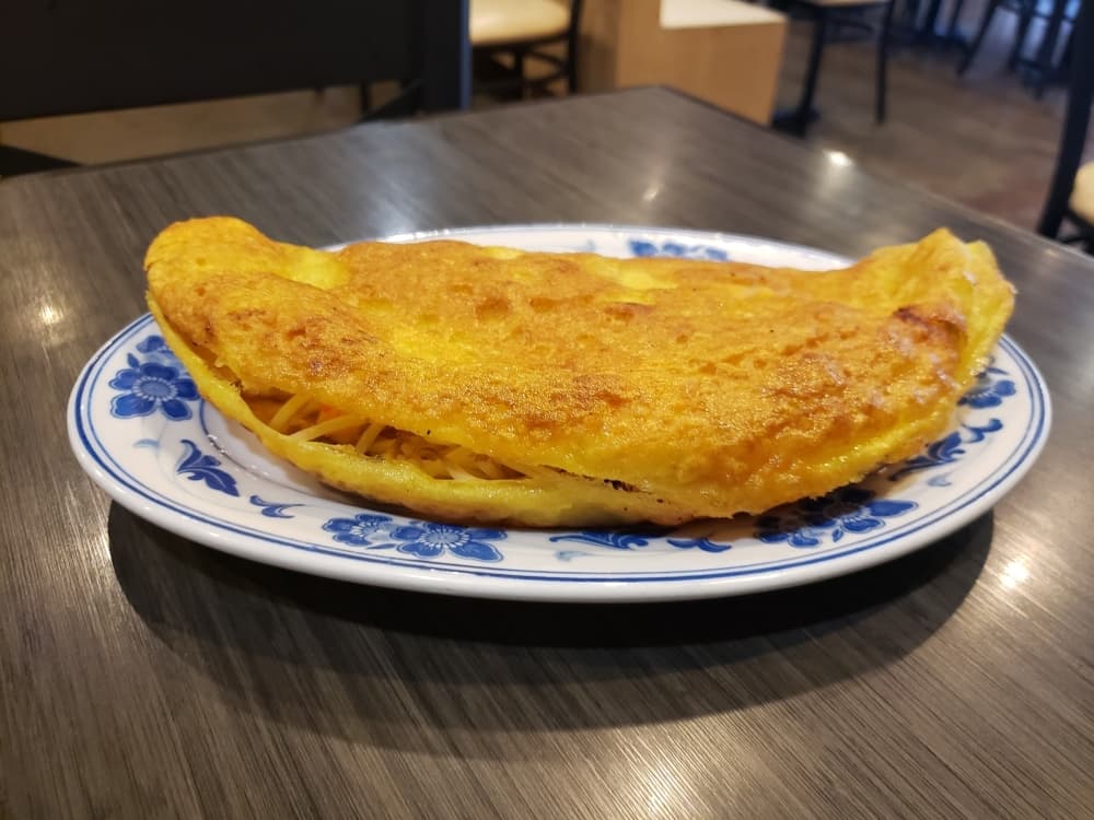 Banh Xeo ($11.95) is a Vietnamese rice crepe that is crispy, pan-fried and filled with a choice of protein and bean sprouts. (Stephen Hunt/Community Impact Newspaper)