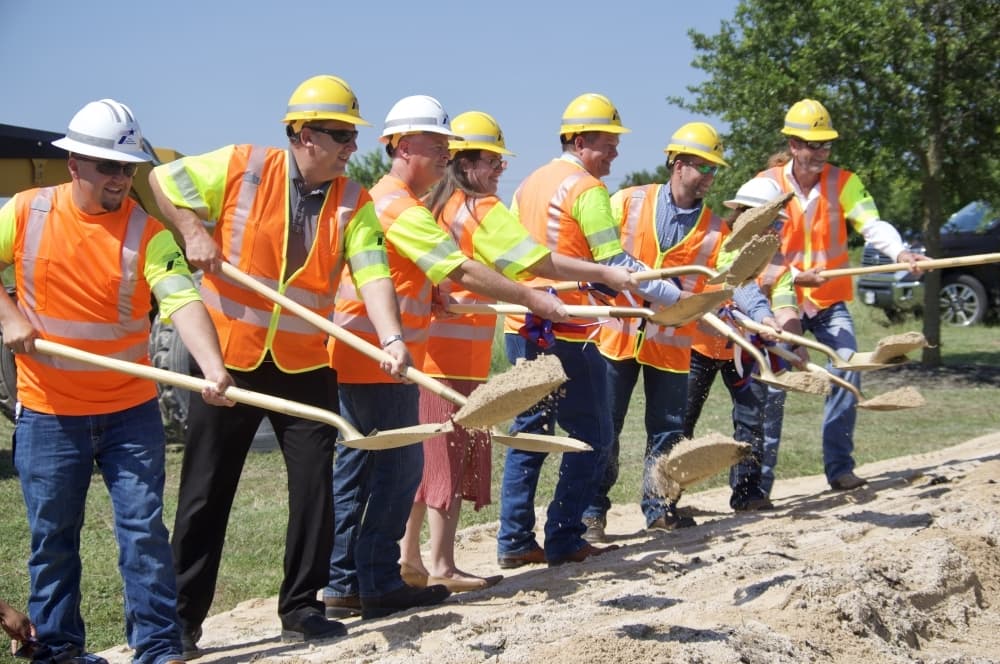 Local leaders, officials and stakeholders turn the first bit of dirt at the FM 2001 groundbreaking event. (Warren Brown/Community Impact Newspaper)