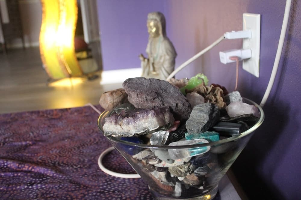 Moonlight Yoga students bring Gibson rocks collected on their travels. The bowl, which sits near Gibson as she instructs, has rocks in it from all over the world. (Colleen Ferguson/Community Impact Newspaper)