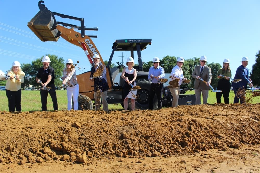 McKinney and the Children's Advocacy Center of Collin County officials fling the first dirt on the Speese Campus project. (Miranda Jaimes/Community Impact Newspaper)