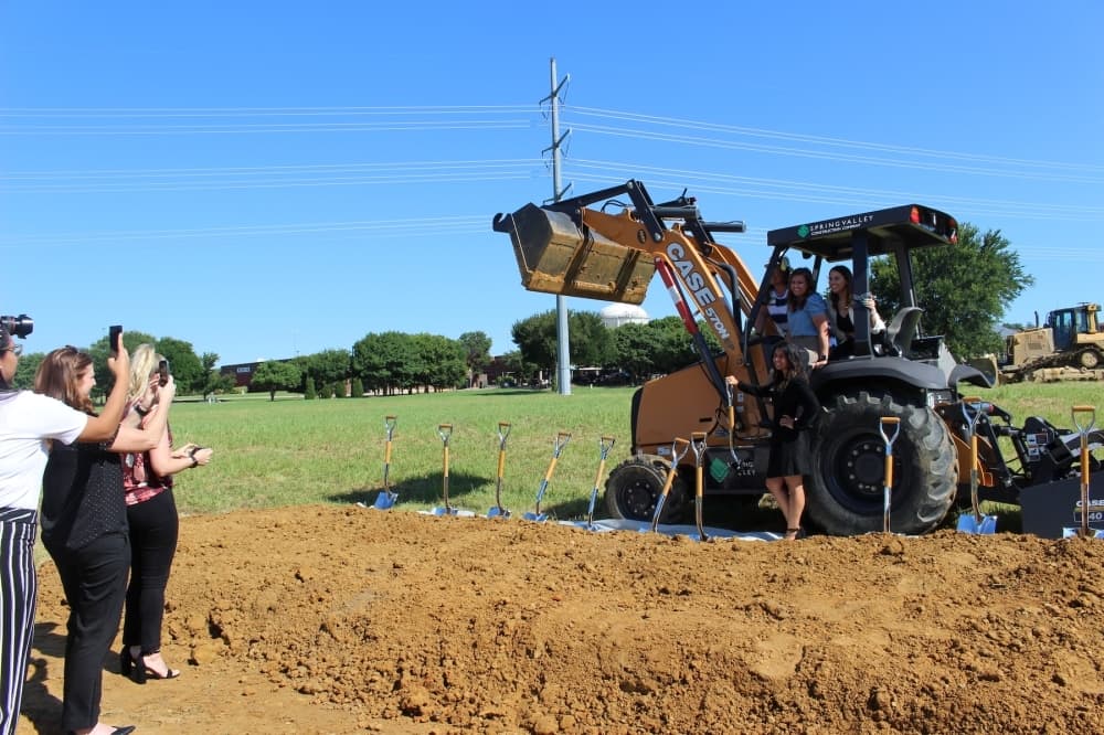 The construction equipment on-site made for a good photo opportunity for those in attendance of the Speese Campus groundbreaking. (Miranda Jaimes/Community Impact Newspaper)