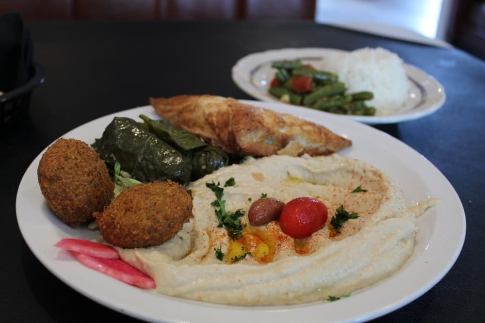 The vegetarian plate offers a sampling of the menu, including falafel, dolmas and spanakopita. (Kira Lovell/Community Impact Newspaper)