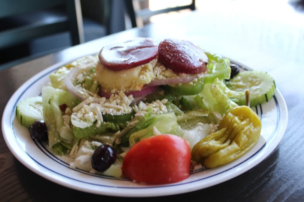 The Greek salad ($7.49) can be customized with a variety of toppings including lettuce, tomatoes, cucumbers, red onions, green peppers, kalamata olives, pepperoncinis, potato salad, feta cheese and beets. (Erick Pirayesh/Community Impact Newspaper)