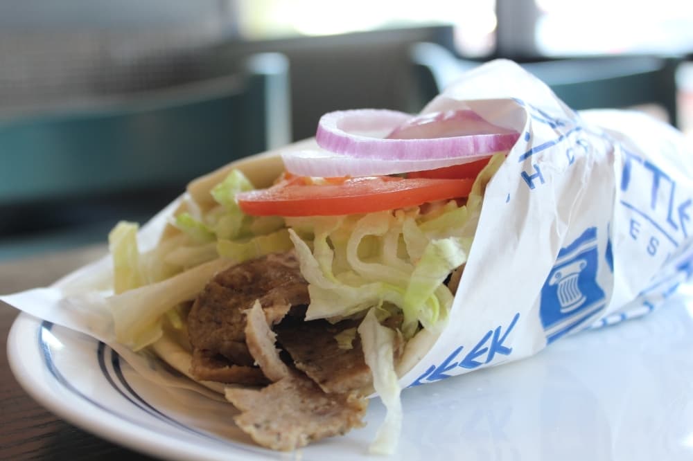 The Gyro Pita ($7.49) is paired with lettuce, tomatoes, onions and tzatziki sauce wrapped in warm pita bread. (Erick Pirayesh/Community Impact Newspaper)