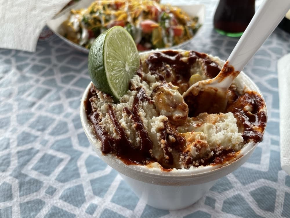 Fresh corn roasted daily is dressed with mayonnaise, cheese and Al Chile’s special sauce made in-house. (Carrie Taylor/Community Impact Newspaper)