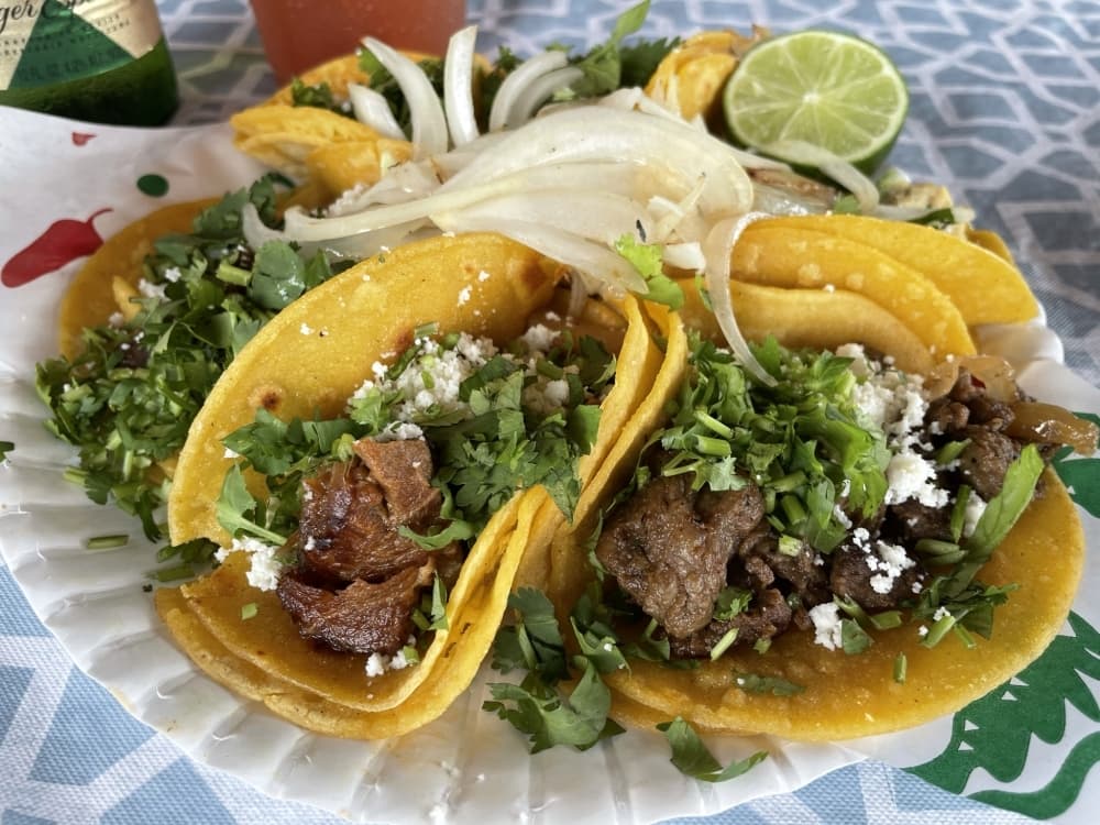 Tacos feature a choice of meet, cilantro, queso fresco and grilled onions. (Carrie Taylor/Community Impact Newspaper)