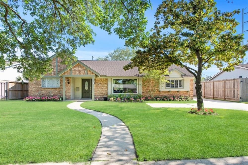5475 Beechnut Street, Houston: A remodeled 1959 home, this traditional home features a host of offerings including an upgraded pool, leaded glass door and windows, remodeled kitchen with granite counters and subway tile backsplash, stainless steel appliances and a stainless steel sink, as well as a brushed nickel faucet and hardware.  Bamboo floors line the house, while tile lines the kitchen. The house features an open floor plan that has a brick fireplace with gas logs, a French door to a covered patio, and a remodeled guest bathroom. 3 bed, 2 full baths/2,305 sq. ft. Sold for $420,001-$482,000 on June 8. (Courtesy Houston Association of Realtors)