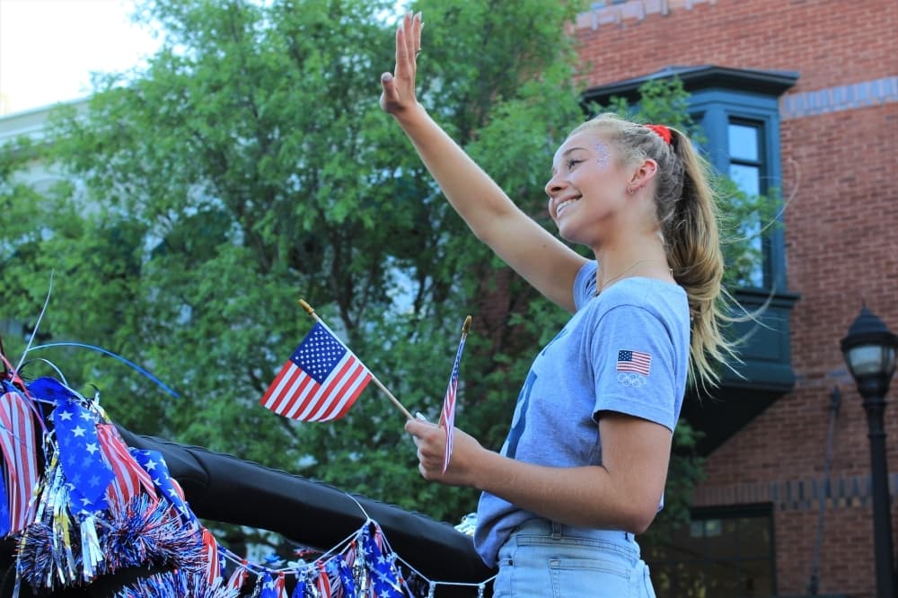 Hailey Hernandez, 18, waves at the crowd on July 9 in Town Square. (Sandra Sadek/Community Impact Newspaper)