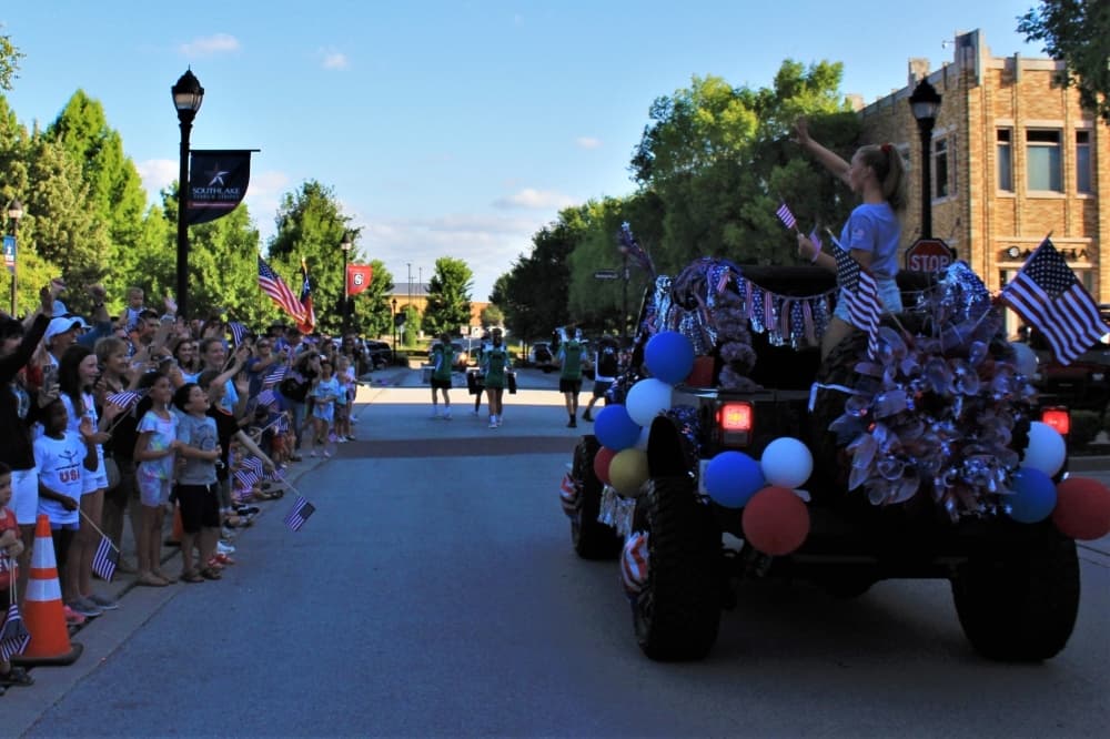 Hailey Hernandez, 18, waves at the crowd on July 9 in Town Square. (Sandra Sadek/Community Impact Newspaper)