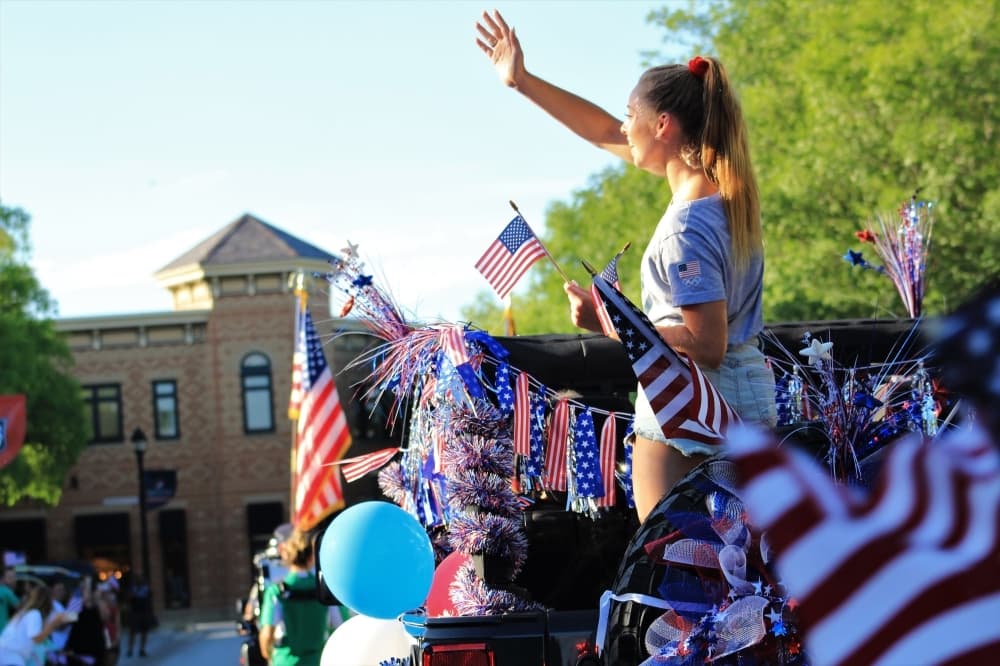 Hailey Hernandez, 18, waves at the crowd on July 9 in Town Square. (Sandra Sadek/Community Impact Newspaper)