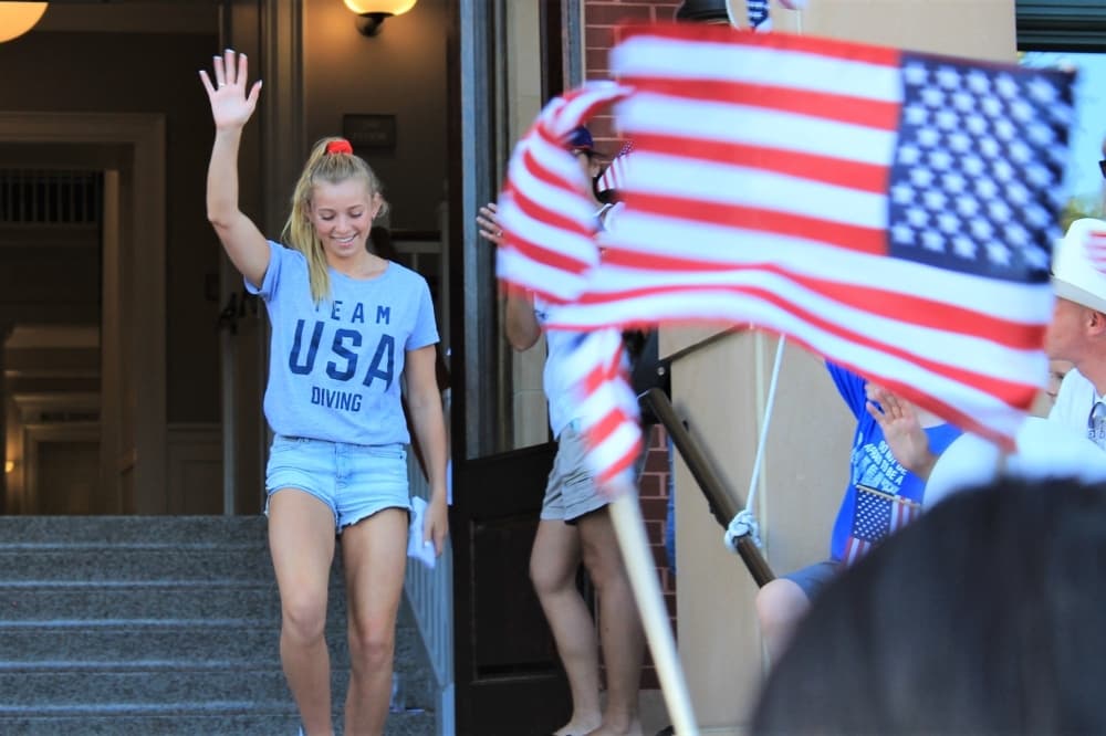 Hailey Hernandez, 18, waves at the crowd on July 9 in Town Square. (Sandra Sadek/Community Impact Newspaper)