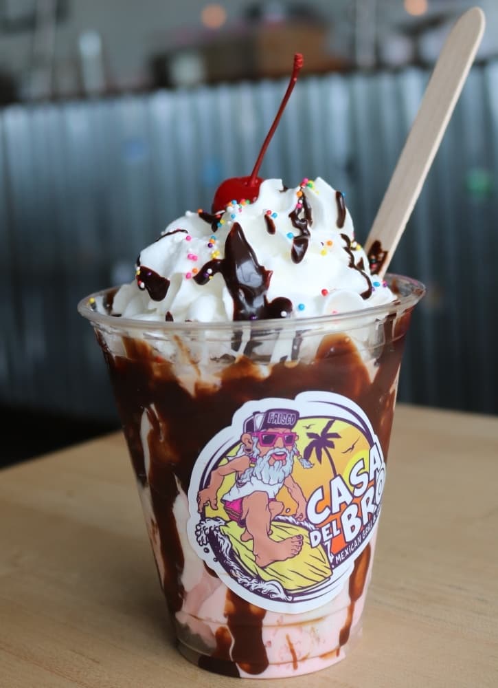 The Strawberry Hot Fudge Sundae ($6.35) includes two scoops of strawberry ice cream, hot fudge drizzle, whipped cream and a cherry on top. (Kaushiki Roy/Community Impact Newspaper)