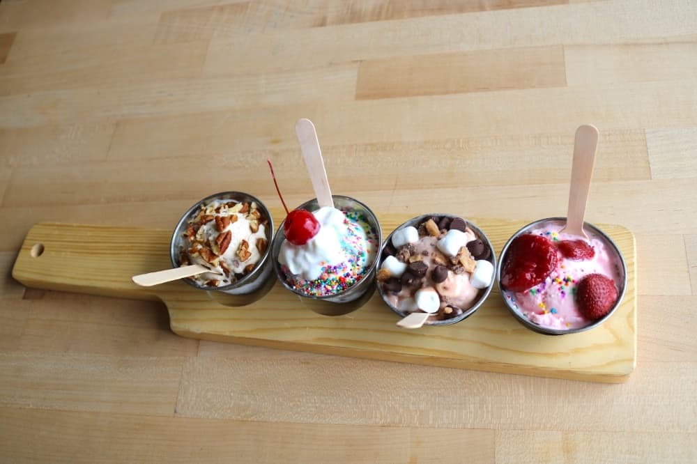 (Left to right) Single scoop cups of butter pecan, cake batter, s'mores and strawberry ice cream ($3.95 each). (Kaushiki Roy/Community Impact Newspaper)