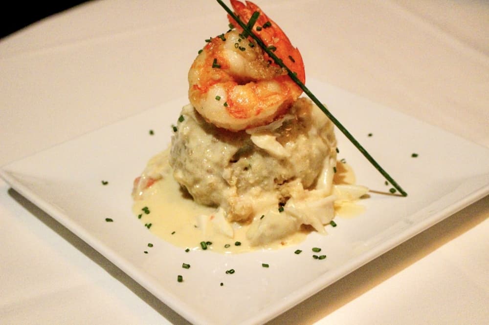The crabcake (0) is a fan favorite appetizer that features jumbo lump crab, lemon butter and jumbo shrimp [consider cutting due to angle]. (Andrew Christman/Community Impact Newspaper)