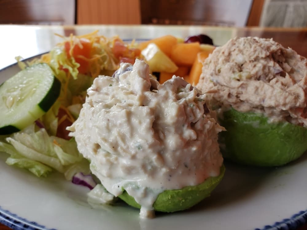 The avocado salad ($13) comes with two stuffed avocados with tuna and/or chicken salad, served with side salad and fresh fruit. (Ali Linan/Community Impact Newspaper)