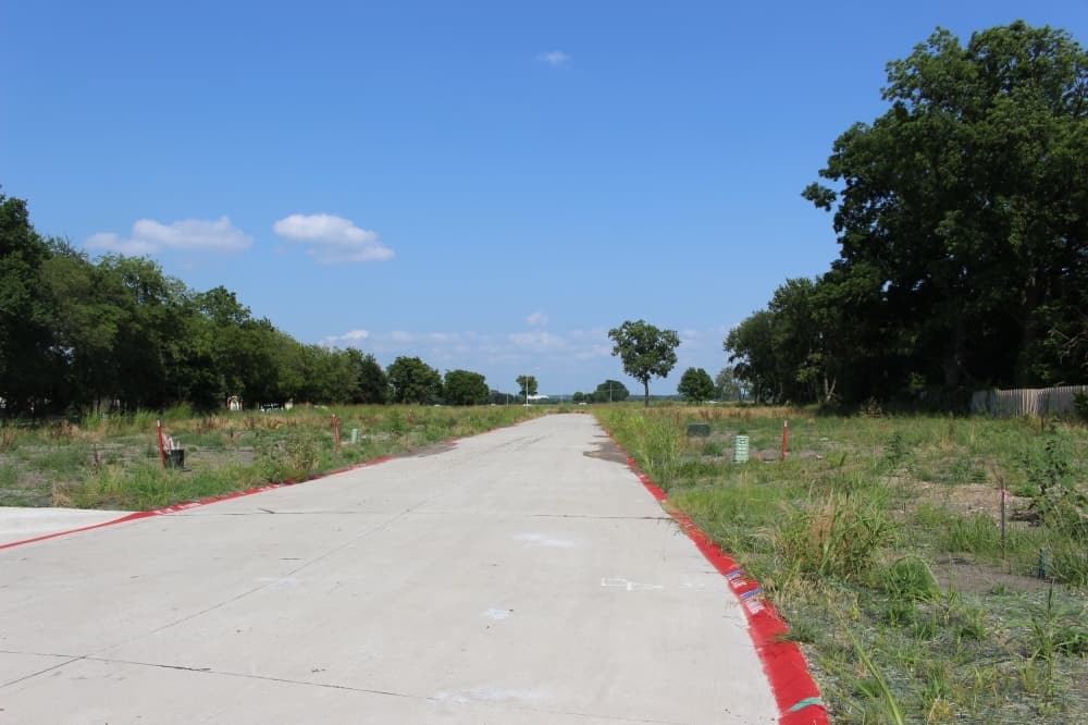 Streets have been paved and streetlights installed at the southeast corner of Bumpas and Fitzhugh streets, where The Cotton Groves container home community will be. (Miranda Jaimes/Community Impact Newspaper)