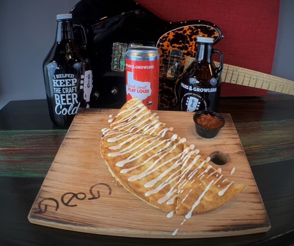 Charcuterie "pedal" boards feature seasonal meats, cheese, fruits, nuts and olives. Customers can choose from a board to serve either two or four people. (Courtesy Guitars & Growlers)
