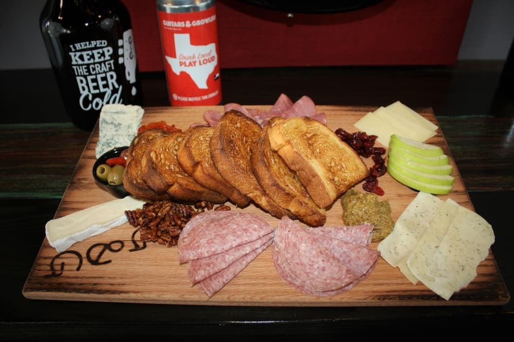 Charcuterie "pedal" boards feature seasonal meats, cheese, fruits, nuts and olives. Customers can choose from a board to serve either two or four people. (Courtesy Guitars & Growlers)