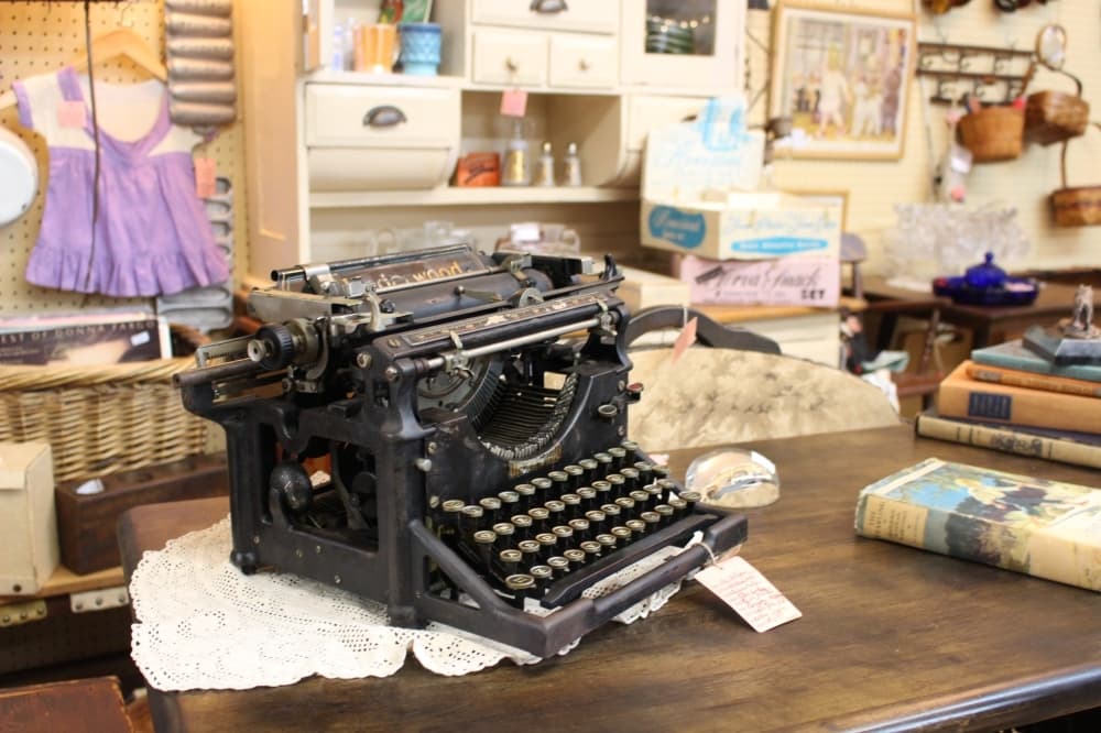 Several vintage typewriters can be found among the shelves at KT Antiques. (Morgan Jones/Community Impact Newspaper)