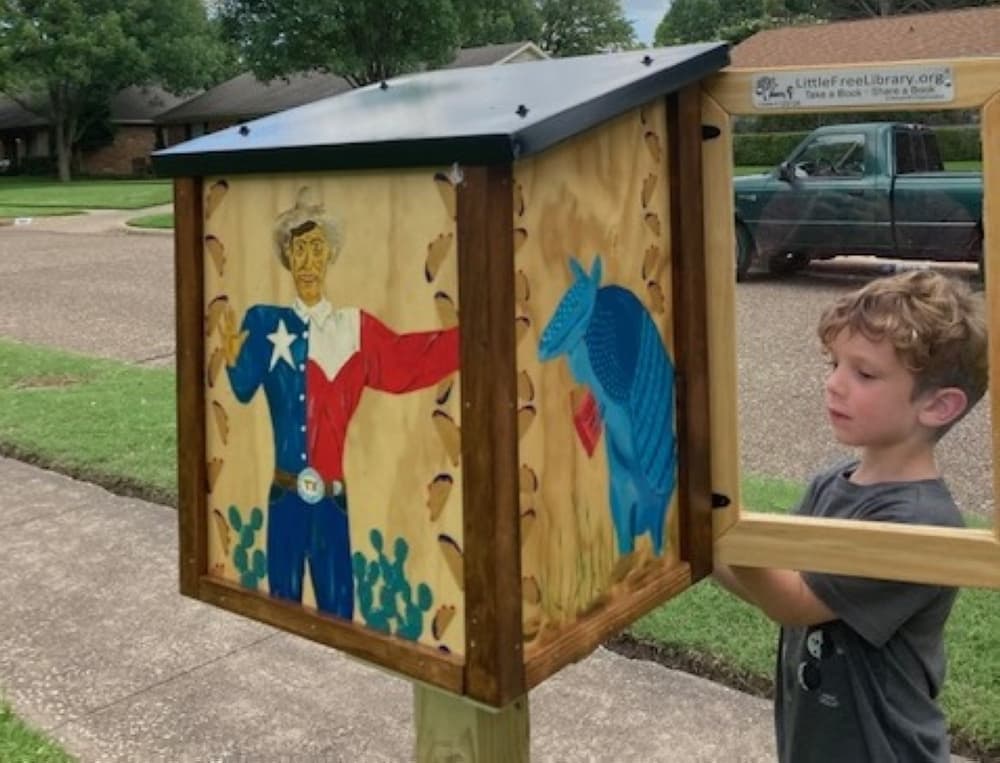 Child at a Little Free Library.