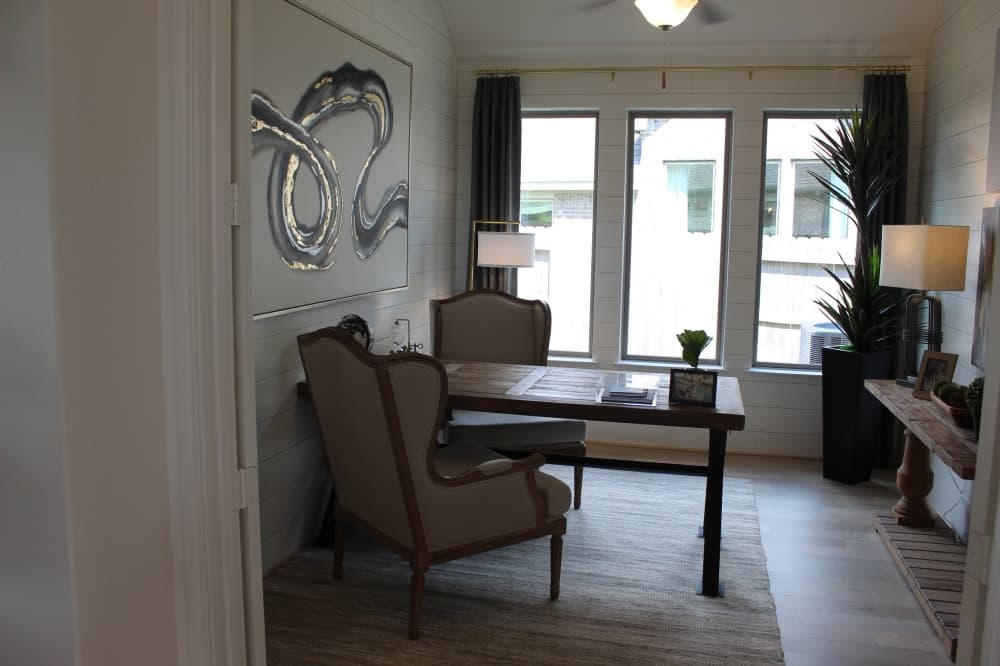 Next to the kitchen, there is a study with a contemporary design and large windows to let in plenty of natural light. (Savannah Kuchar/Community Impact Newspaper)