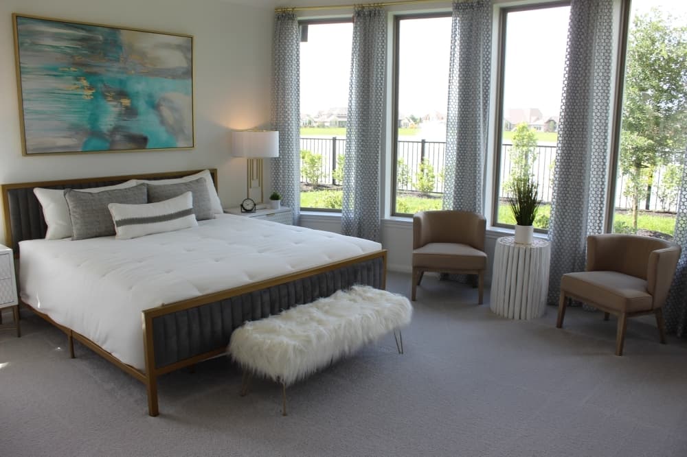 Toward the back of the house, the primary bedroom looks out onto the backyard with a view of the lake. (Savannah Kuchar/Community Impact Newspaper)