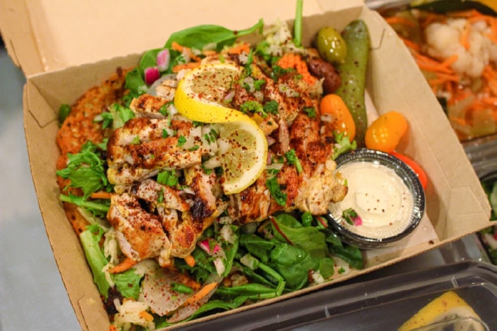 The Chicken shawarma board comes with grilled chicken thighs, tomato, olive, basil, red onion and flatbread ($15).