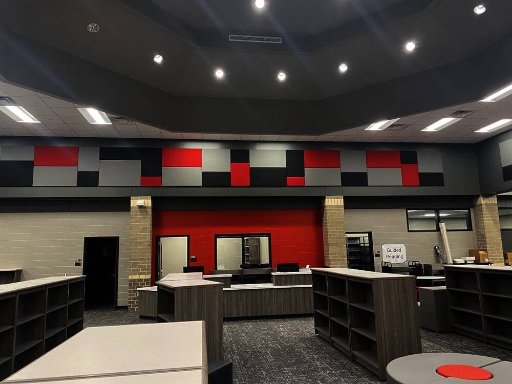 The library is located off the cafeteria and debuts the red and silver school colors. (Ally Bolender/Community Impact Newspaper) 