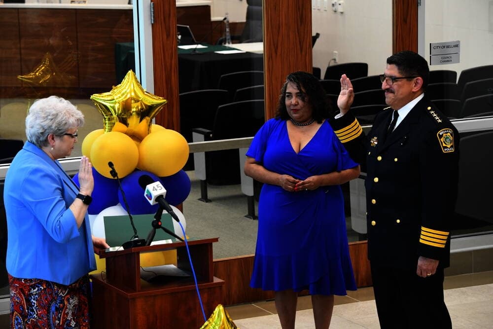 Onesimo Lopez is sworn in as Bellaire’s new police chief, as his wife, Faby, looks on. (Hunter Marrow/Community Impact Newspaper)