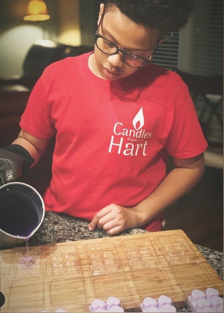 Hart Wilson works on making candles for his small business. (Courtesy Michael Wilson).