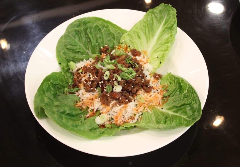 Korean beef lettuce wraps ($10): Korean spiced beef is served with white rice and sesame seeds. (Savannah Kucher/Community Impact Newspaper)