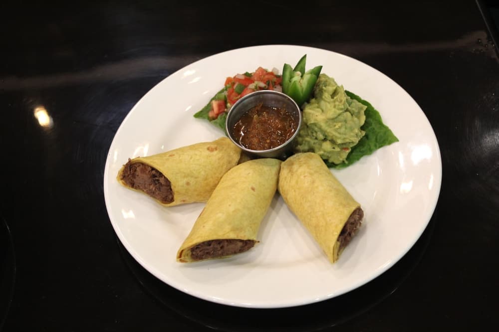 Short rib tacos ($12 for three, $15 for six): The popular appetizer is served with guacamole and pico de gallo. (Savannah Kucher/Community Impact Newspaper)