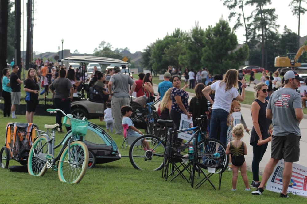 A large crowd gathered to watch Biles and Chiles drive by. (Ally Bolender/Community Impact Newspaper)