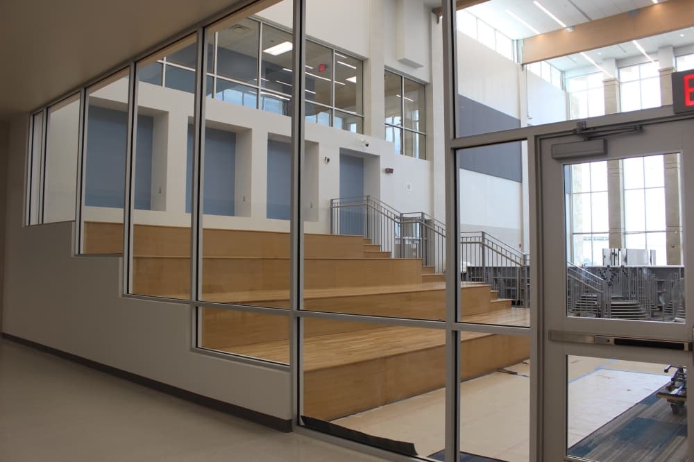 The school's library is at the rear of the campus and is visible through glass. (Miranda Jaimes/Community Impact Newspaper)