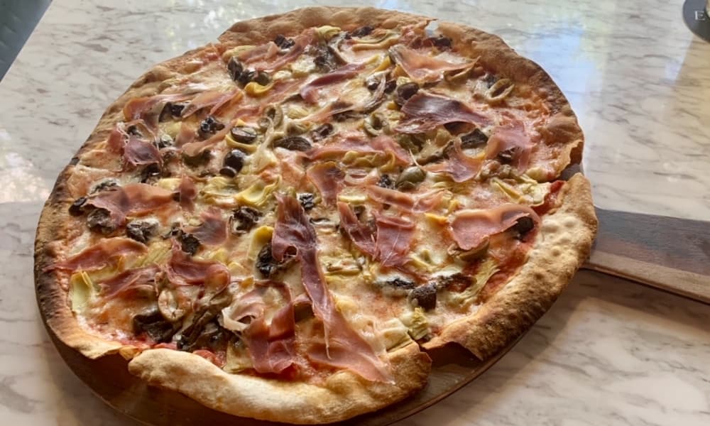 Capricciosa Pizza Tonda comes topped with artichokes, prosciutto, olives and mushrooms. ($19)
 (Greg Perliski/Community Impact Newspaper)