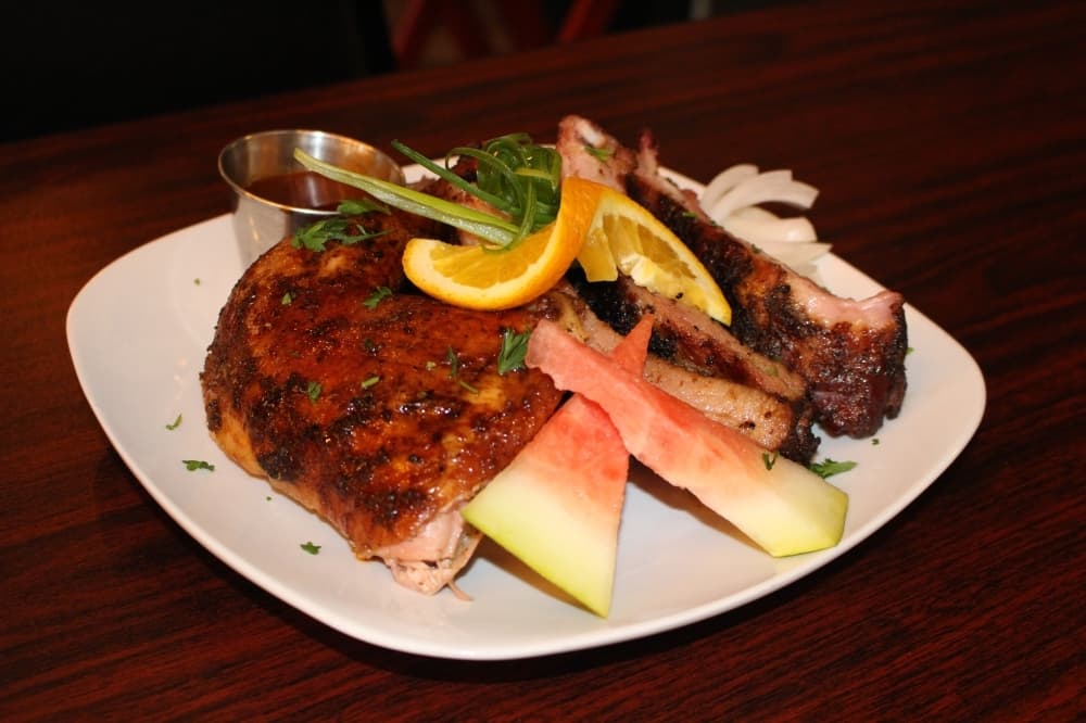 The three-meat combo includes ribs, smoked chicken and chopped beef with a homemade barbecue sauce ($21.99). Customers can choose between chopped beef, ribs, links, chicken or pulled pork. (Ally Bolender/Community Impact Newspaper)